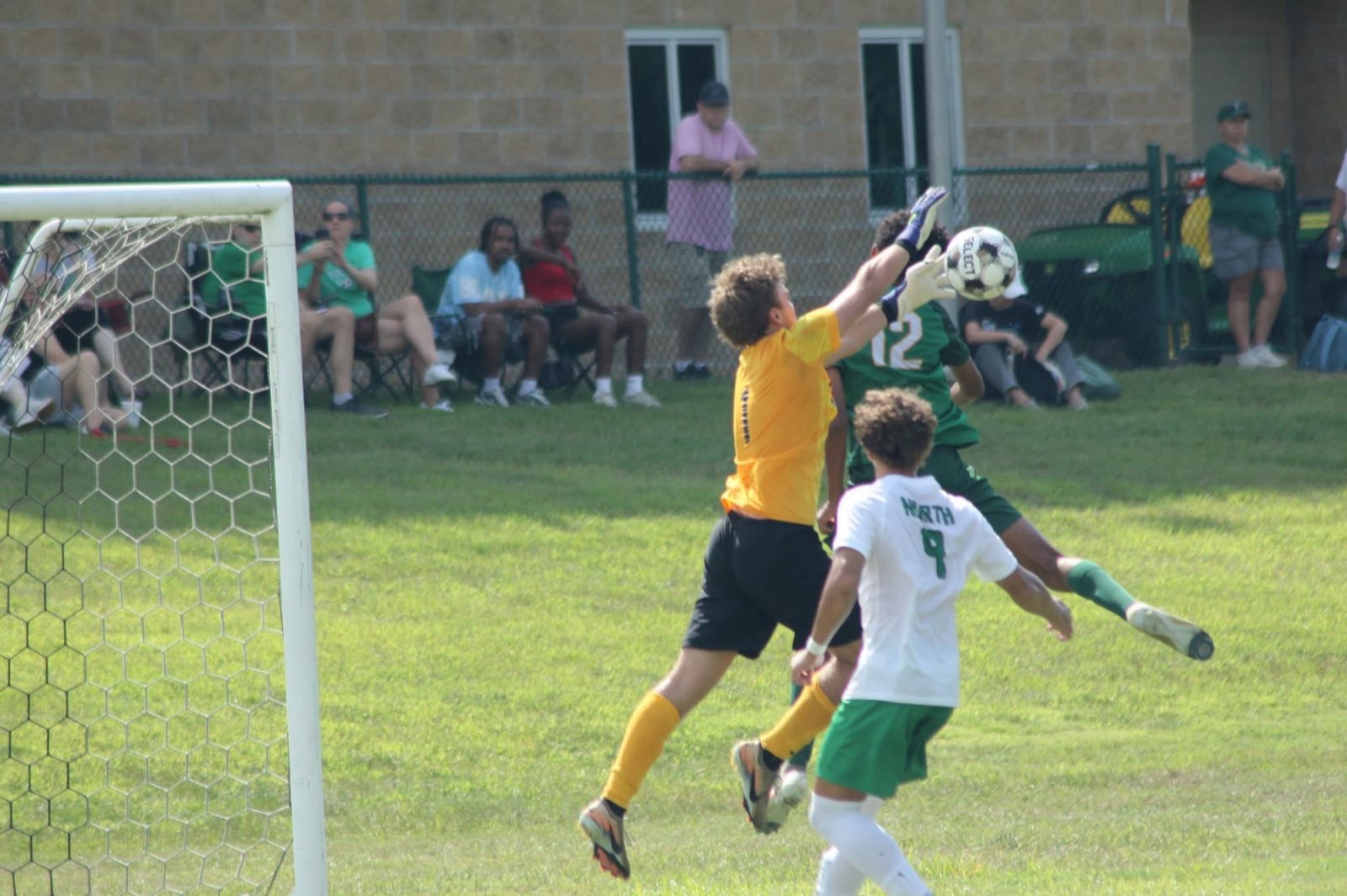 The keeper punches clear over traffic