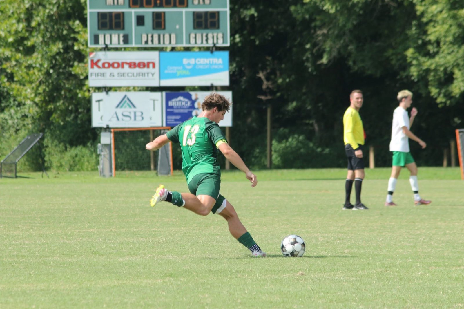 Cade Davidson strikes the ball beneath the scoreboard
