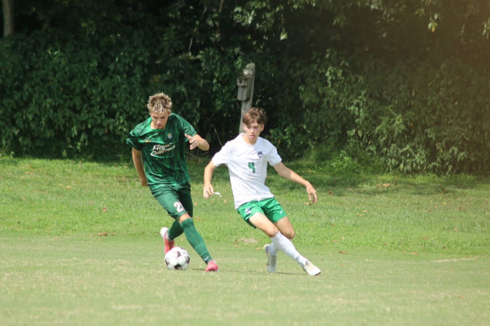 A Floyd Central player drives past an Evansville North defender