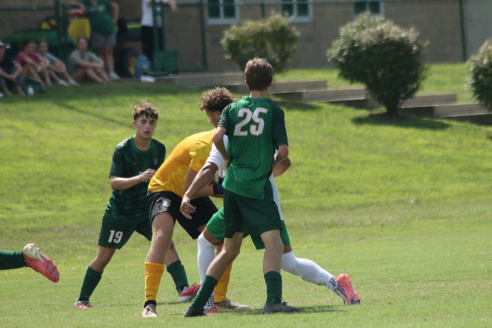 Floyd Central varsity players battling for the ball in front of the home crowd